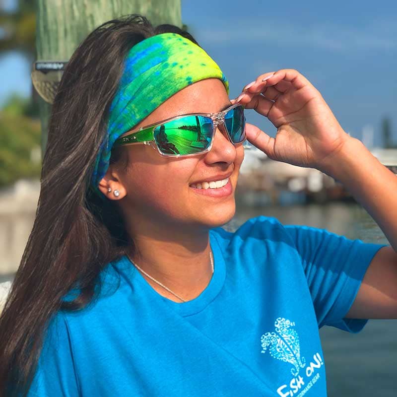 Beautiful model Mercedes G wearing Fish 419 Polarized HD Perfection sunglasses and a Dorado Sun Gaiter while sitting on a boat in Florida.